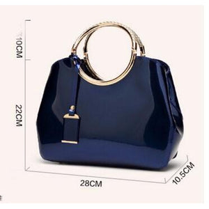 Women Shiny Glossy Faux-Leather Handbag with a Decorative Brass Buckle