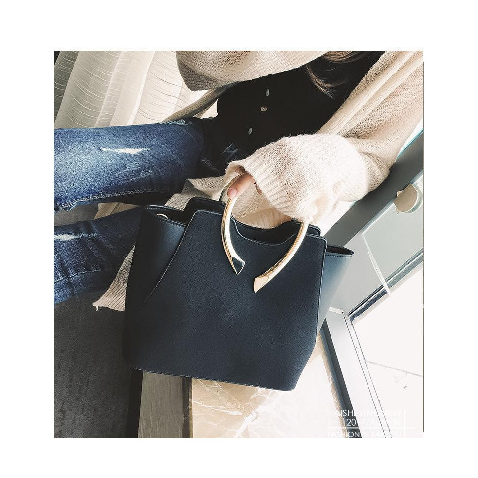 Women Black Tote Leather Handbag in women hand